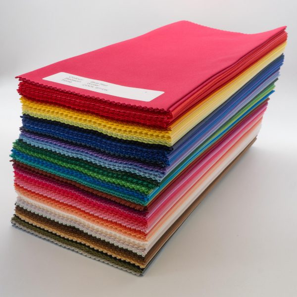 Close up of neat stack of bundle of 120 colours of direct colour drapes, diagonal full image slightly from above